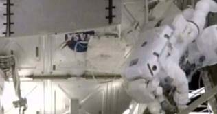 Space station alarm delays Atlantis crew spacewalk